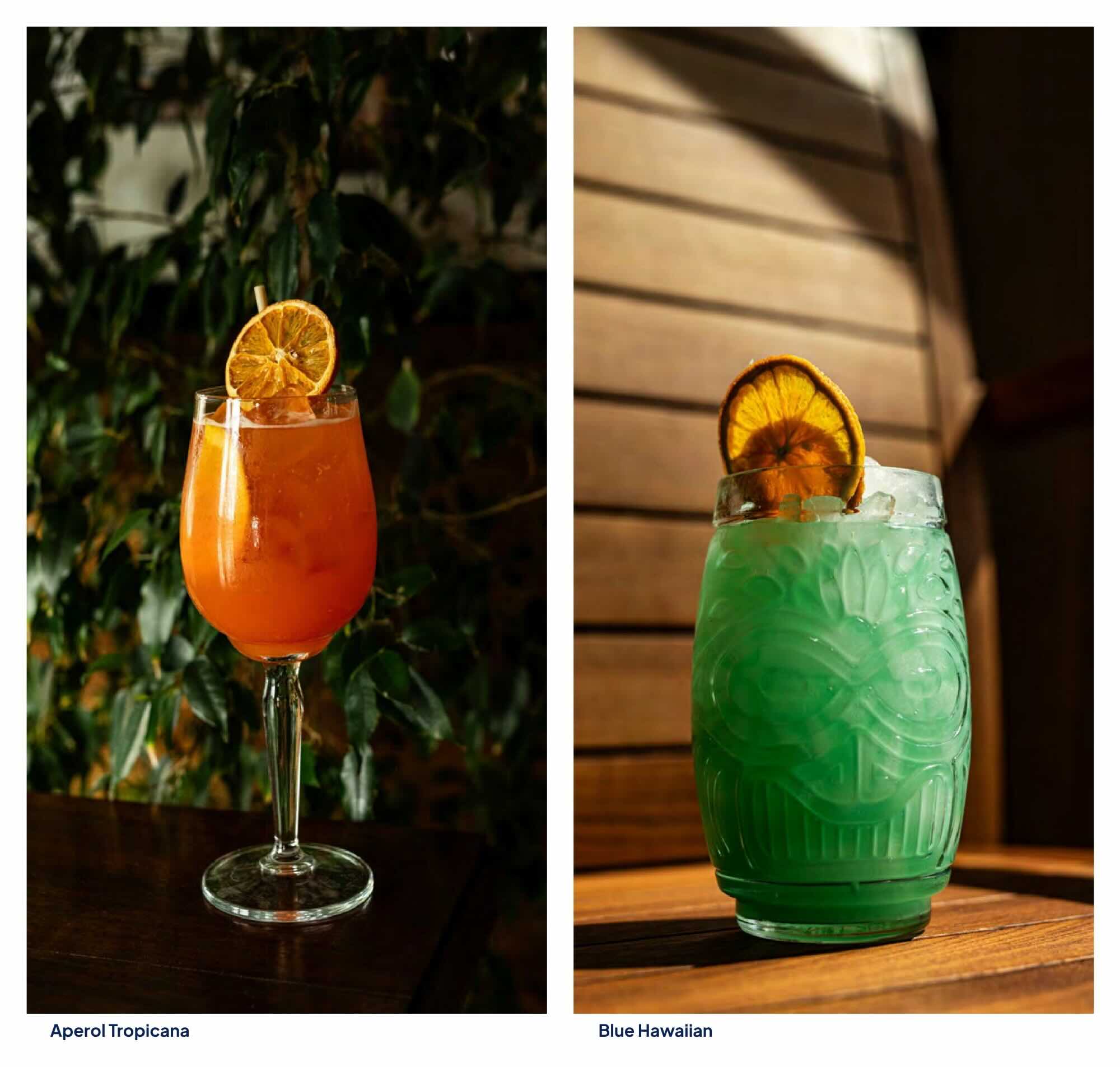 Vibrant orange, refreshing Aperol Tropicana cocktail garnished with a dried orange wheel at Vogue Boat Restaurant. Exotic, ice-cold Blue Hawaiian cocktail served in a unique tiki glass at Vogue Boat Restaurant in Budapest.